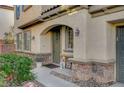 Charming home exterior featuring a green front door, stone accents, and well-maintained landscaping at 9715 Aleutian St, Las Vegas, NV 89178