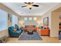 Bright living room with comfortable seating, ceiling fan, and natural light, creating a relaxing atmosphere at 9715 Aleutian St, Las Vegas, NV 89178