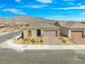 Charming single-story home featuring a desert landscape, brick driveway, and mountain views at 10186 Zeta Tucana St, Las Vegas, NV 89143