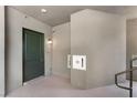 Hallway featuring a neutral color palette with a dark door with stylish handle and fire department valve cabinet at 128 Los Cabos Dr # 202, Las Vegas, NV 89144