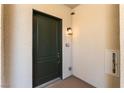 Elegant entrance door of condo with stylish outdoor lantern, and suite number, creating a welcoming entry at 128 Los Cabos Dr # 302, Las Vegas, NV 89144