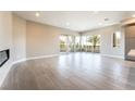 Bright living room featuring sliding doors to balcony, and open space with a modern fireplace at 128 Los Cabos Dr # 302, Las Vegas, NV 89144