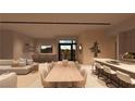 Bright dining room showcasing an expansive table, modern seating, and an open layout to the living areas and kitchen at 165 Still Shores St, Henderson, NV 89011