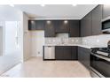 Open kitchen featuring stainless steel appliances, dark cabinets, and light countertops at 1801 Flycatch St, Las Vegas, NV 89138
