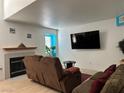 Cozy living room features a fireplace, hardwood floors, and ample natural light at 213 Luninborg St, Henderson, NV 89074