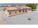 Attractive single-story home featuring desert landscaping, a clay tile roof, and a welcoming front entrance at 2530 Commercial Dr, Pahrump, NV 89048