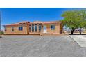 Inviting single-story home featuring desert landscaping, a clay tile roof, and a welcoming front entrance at 2530 Commercial Dr, Pahrump, NV 89048