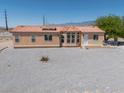 Attractive single-story home boasts large windows, desert landscaping, and a red-tile roof at 2530 Commercial Dr, Pahrump, NV 89048