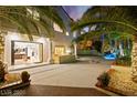 Beautiful outdoor space with a built-in grill, patio area, and lush tropical landscaping at 2608 Sun Reef Rd, Las Vegas, NV 89128