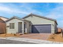 Charming single-story home featuring a two-car garage and desert landscaping at 2721 Avril Point St, Las Vegas, NV 89156