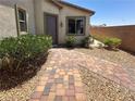 Inviting walkway leading to the front door, complemented by lush greenery and desert landscaping for a warm welcome at 2772 Brinkley Manor St, Laughlin, NV 89029