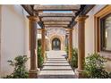 Charming entrance featuring a stone pathway, column supports, and a pergola at 38 Pebble Dunes Ct, Las Vegas, NV 89141