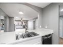 Modern kitchen featuring an open layout with stainless steel sink, and views to the living area and balcony at 5000 Red Rock St # 120, Las Vegas, NV 89118