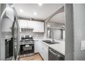 Well-lit kitchen featuring stainless steel appliances, white cabinets, and quartz countertops at 5000 Red Rock St # 120, Las Vegas, NV 89118