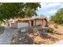 Inviting one-story home with a tile roof and low-maintenance desert landscaping at 5101 Renault Ave, Las Vegas, NV 89142