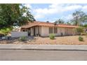 Cozy one-story home with a tile roof, minimal landscaping, and mature trees at 5101 Renault Ave, Las Vegas, NV 89142