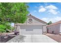 Charming home featuring a well-maintained garage and a lush tree in the front yard at 5228 Harmony Ave, Las Vegas, NV 89107