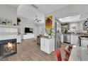 Open-concept living space with fireplace, flows into kitchen with stainless steel appliances at 5228 Harmony Ave, Las Vegas, NV 89107