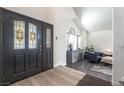 Inviting entryway boasts a decorative front door and leads into a spacious living area with vaulted ceilings at 5381 Waving Sage Dr, Las Vegas, NV 89149