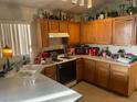 Functional kitchen features linoleum countertop and floors with wooden cabinetry at 5429 Chela Dr, Las Vegas, NV 89120