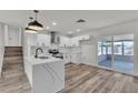 Updated kitchen featuring white cabinets, stainless appliances, and an island with marble countertops at 5617 Reiter Ave, Las Vegas, NV 89108