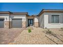 Attractive single-story home featuring a three-car garage and well-maintained desert landscape at 5851 Slate Rock Ct, Las Vegas, NV 89149