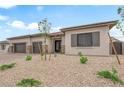 Charming single-story home with desert landscaping, complemented by a three-car garage at 5851 Slate Rock Ct, Las Vegas, NV 89149