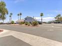 Exterior shot of the property showcasing the building's design, landscaping, and parking at 5861 Medallion Dr # 202, Las Vegas, NV 89122