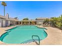 Community pool with lounge chairs, well maintained landscaping, and shaded pergola area at 5861 Medallion Dr # 202, Las Vegas, NV 89122