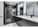 Modern bathroom boasts dual vanities, a glass-enclosed shower, and elegant marble flooring at 649 Tranquil Jade St, Las Vegas, NV 89138