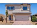 Inviting two-story house showcasing a two-car garage and colorful front door at 6713 Violet Cascade Ave, Las Vegas, NV 89156