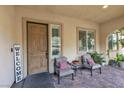 Inviting front porch with stylish seating, door, and 'Welcome' sign at 7854 Brianna Cheerful Ave, Las Vegas, NV 89178