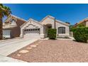 Charming single-story home featuring desert landscaping, an attached two-car garage, and a tile roof at 87 Ginger Lily Ter, Henderson, NV 89074