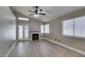 Cozy living room with a fireplace, French doors, and large windows for plenty of natural light at 87 Ginger Lily Ter, Henderson, NV 89074