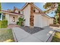 Two-story home with red tile roof, palm tree, and charming front door at 8809 Beach Front Dr, Las Vegas, NV 89117
