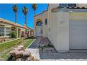 Home featuring arched entryway with tile roof, complemented by drought resistant landscaping at 901 Carnival Ave, Las Vegas, NV 89123