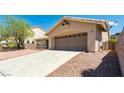 Charming single-story home featuring an attached two-car garage and low maintenance desert landscaping at 902 Possum Hill St, Henderson, NV 89014