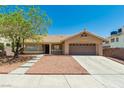 Inviting single-story house has desert landscaping, mature tree, and an attached two-car garage at 902 Possum Hill St, Henderson, NV 89014