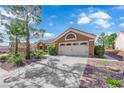 Well-maintained home with desert landscaping, a tile roof, and a two-car garage at 9237 Quail Ridge Dr, Las Vegas, NV 89134
