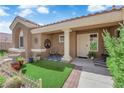 Charming front porch with artificial turf, stylish decor and seating for two at 9237 Quail Ridge Dr, Las Vegas, NV 89134