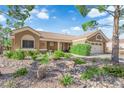 Inviting single-story house with desert landscaping, tile roof, and a cozy front patio at 9237 Quail Ridge Dr, Las Vegas, NV 89134