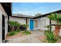 Inviting home entrance with a bright blue door, desert landscaping, and black accents at , Henderson, NV 89015