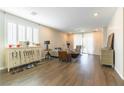 Open-concept living room boasts hardwood floors, light-filled windows and neutral wall colors at 10711 Silver Pond Ave, Las Vegas, NV 89135
