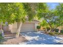 Inviting two-story home featuring mature landscaping, a two car garage and tiled roof at 10716 Aire Dr, Las Vegas, NV 89144