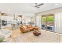 Cozy living room boasts a comfortable leather sofa, stylish rug, and access to the outdoor patio at 10890 Red Yucca Dr, Las Vegas, NV 89138