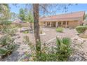 Well-maintained backyard featuring decorative rock, mature landscaping and low-water plants at 1174 Monogram Way, Las Vegas, NV 89123
