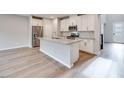 Bright, modern kitchen features stainless appliances, white cabinets, and island at 11922 Glide Reflection Ave, Las Vegas, NV 89138