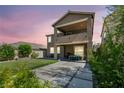 Expansive backyard with a covered patio, second story balcony and ample space for outdoor activities at 12290 Terrace Verde Ave, Las Vegas, NV 89138