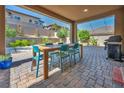 Inviting covered patio featuring a dining area and outdoor grill, perfect for entertaining at 12290 Terrace Verde Ave, Las Vegas, NV 89138