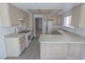 Bright kitchen features tile floors, wood cabinets, and white appliances at 1349 Goldenglow Rd, Las Vegas, NV 89108